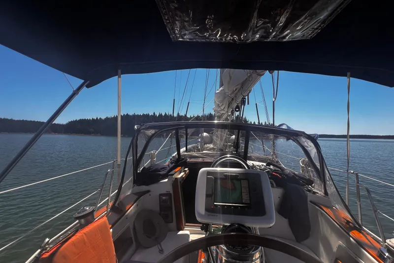 Slide: The Image of Cockpit view of 1982 Pacific Seacraft 37 sailboat on calm waters under clear blue sky. - 10