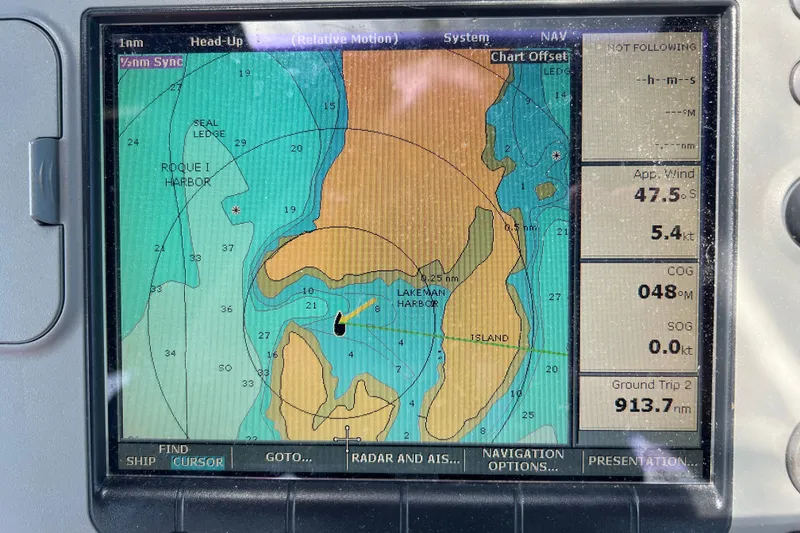 Slide: The Image of Navigation display on a 1982 Pacific Seacraft 37, showing Roque Island and wind data. - 12
