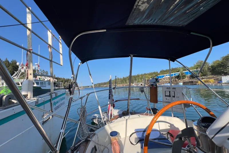 Slide: The Image of Cockpit view of 1982 Pacific Seacraft 37 sailboat docked in a scenic marina. - 13