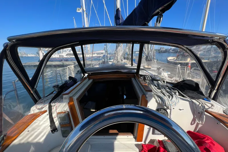 Slide: The Image of Cockpit view of 1982 Pacific Seacraft 37 sailboat, docked with clear blue sky. - 14
