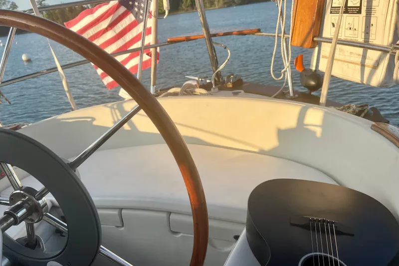 Slide: The Image of Cockpit of 1982 Pacific Seacraft 37 sailboat with guitar and American flag. - 16