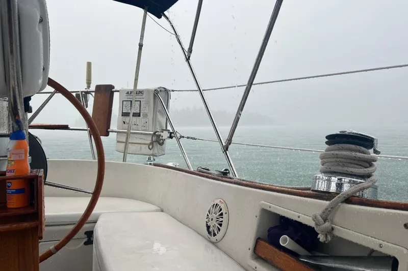 Slide: The Image of Cockpit view of a 1982 Pacific Seacraft 37 sailboat in rainy weather. - 18
