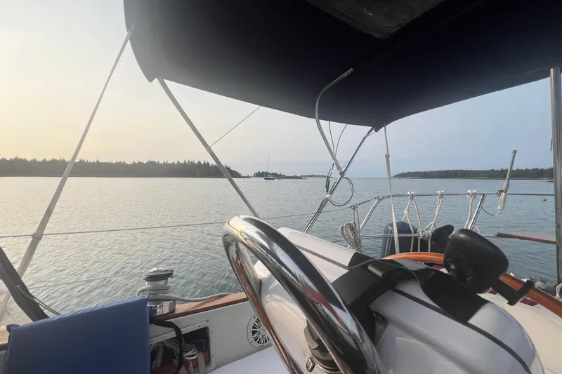 Slide: The Image of Cockpit view from a 1982 Pacific Seacraft 37 sailboat on calm waters at sunset. - 20