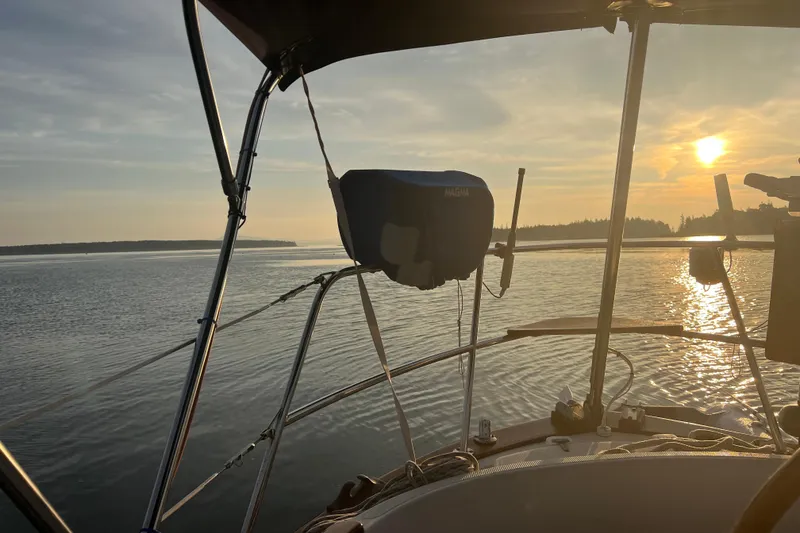 Slide: The Image of Sailboat Pacific Seacraft 37 on calm water at sunset, 1982 model. - 23