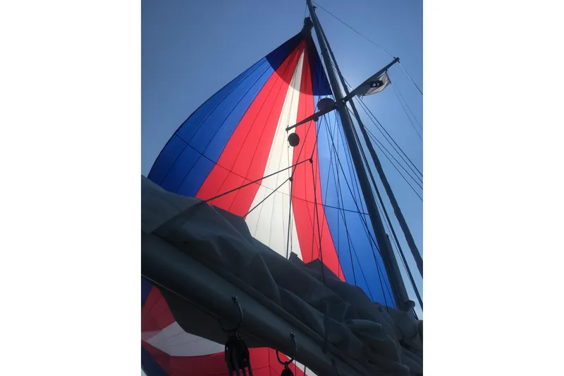 Slide: The Image of Colorful sail on a 1982 Pacific Seacraft 37 against a clear blue sky. - 24