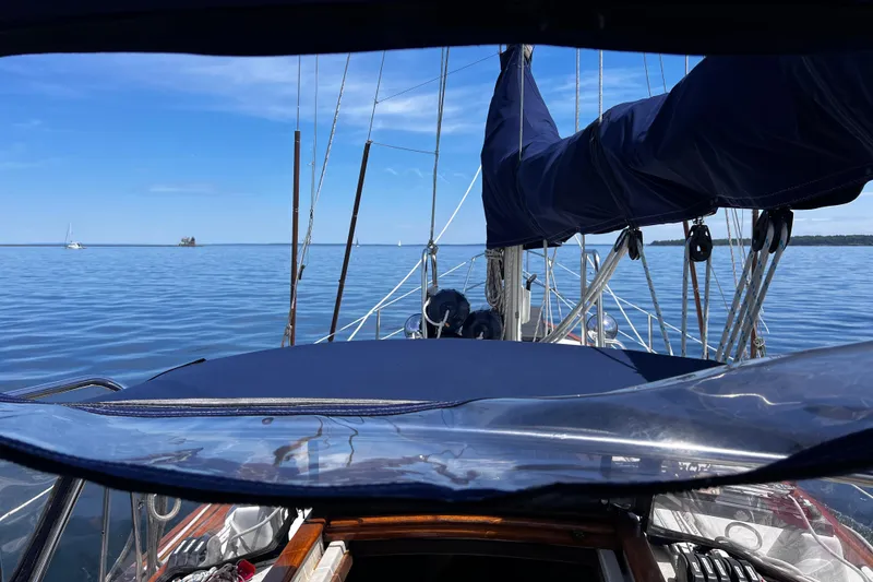 Slide: The Image of 1982 Pacific Seacraft 37 sailboat on calm waters under clear blue sky. - 25