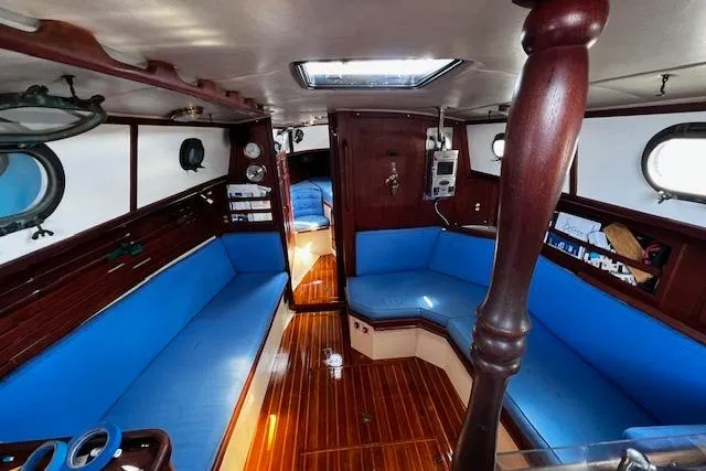 Slide: The Image of Interior of 1982 Pacific Seacraft 37 sailboat with blue seating and wooden finishes. - 36