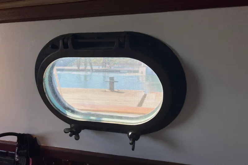 Slide: The Image of Porthole view from 1982 Pacific Seacraft 37 sailboat, showcasing marina scenery. - 47