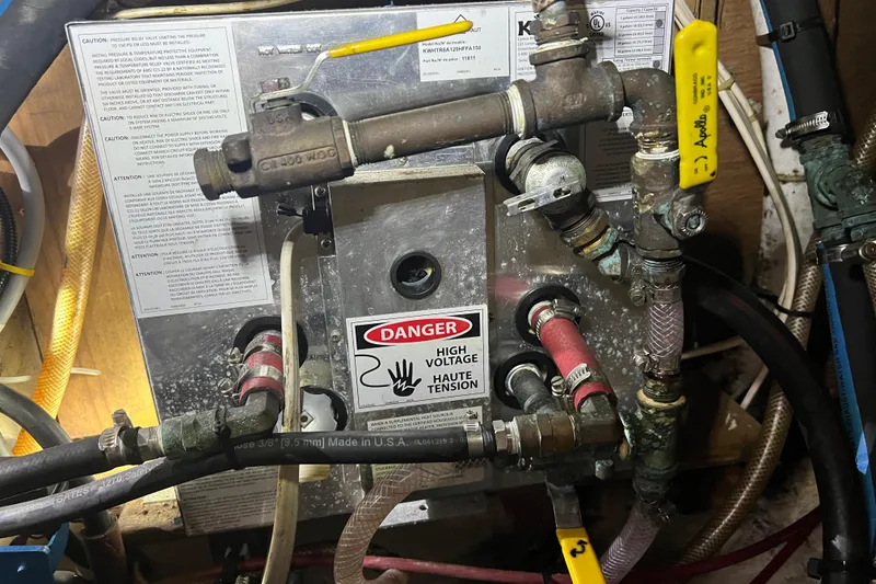 Slide: The Image of Electrical and plumbing system in a 1982 Pacific Seacraft 37 sailboat, featuring high voltage warning. - 55