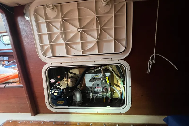 Slide: The Image of Engine compartment of a 1982 Pacific Seacraft 37 sailboat, showing mechanical components. - 56