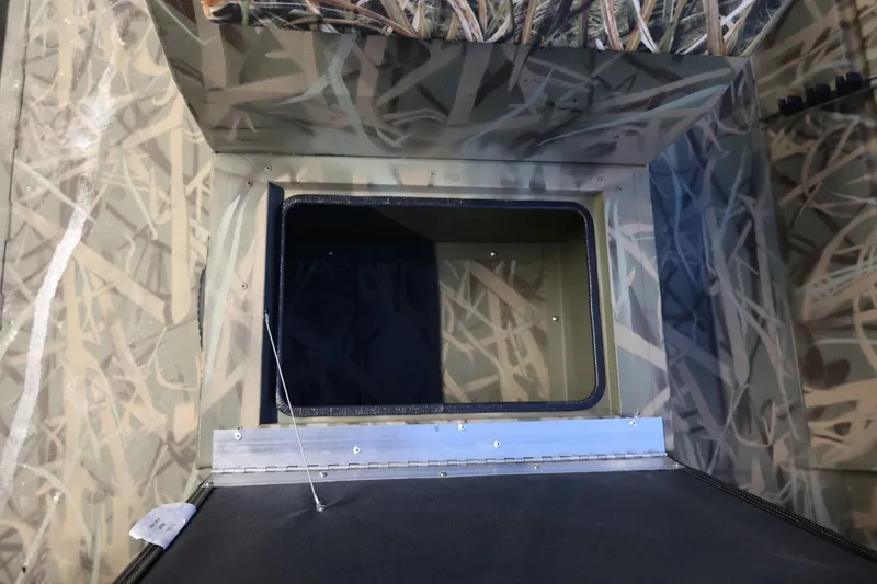 Slide: The Image of 2026 Lund 1870 Predator CC interior with camouflage design and storage compartment. - 11