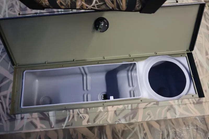 Slide: The Image of 2026 Lund 1870 Predator CC boat storage compartment with camouflage design. - 12