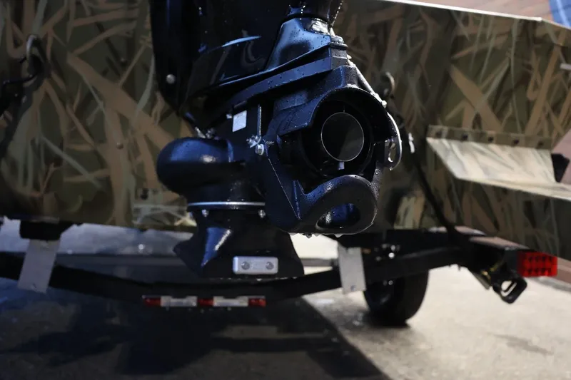 Slide: The Image of 2026 Lund 1870 Predator CC boat with camo design and powerful motor. - 18