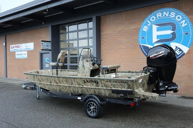 Slide: The Image of 2026 Lund 1870 Predator CC boat with camouflage design and Mercury engine on trailer. - 21