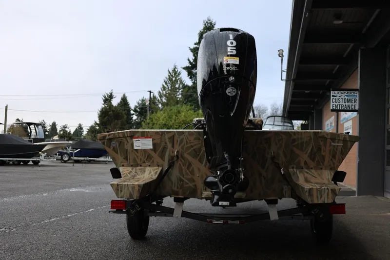 Slide: The Image of 2026 Lund 1870 Predator CC boat with camouflage design and powerful outboard motor. - 24