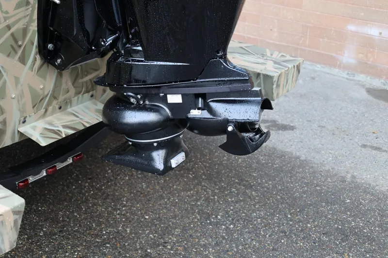 Slide: The Image of 2026 Lund 1870 Predator CC boat engine detail with camouflage design. - 25