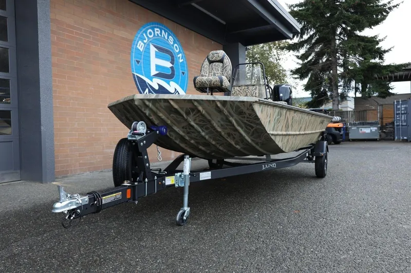 Slide: The Image of 2026 Lund 1870 Predator CC boat on trailer, parked outside Bjornson building. - 27