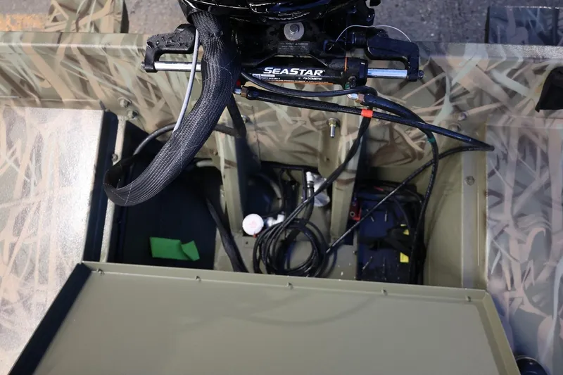 Slide: The Image of Interior view of 2026 Lund 1870 Predator CC boat showing steering and wiring components. - 3