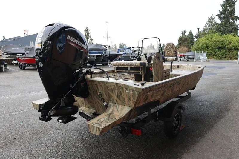 Slide: The Image of 2026 Lund 1870 Predator CC boat with Mercury outboard engine in a parking lot. - 30