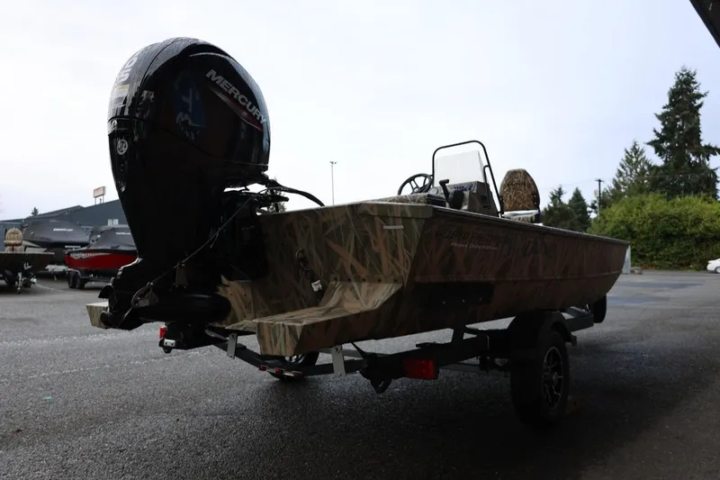 Slide: The Image of 2026 Lund 1870 Predator CC boat with Mercury engine on trailer, outdoors. - 31