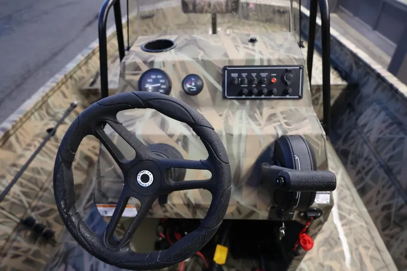 Slide: The Image of 2026 Lund 1870 Predator CC boat dashboard with steering wheel and control panel. - 4