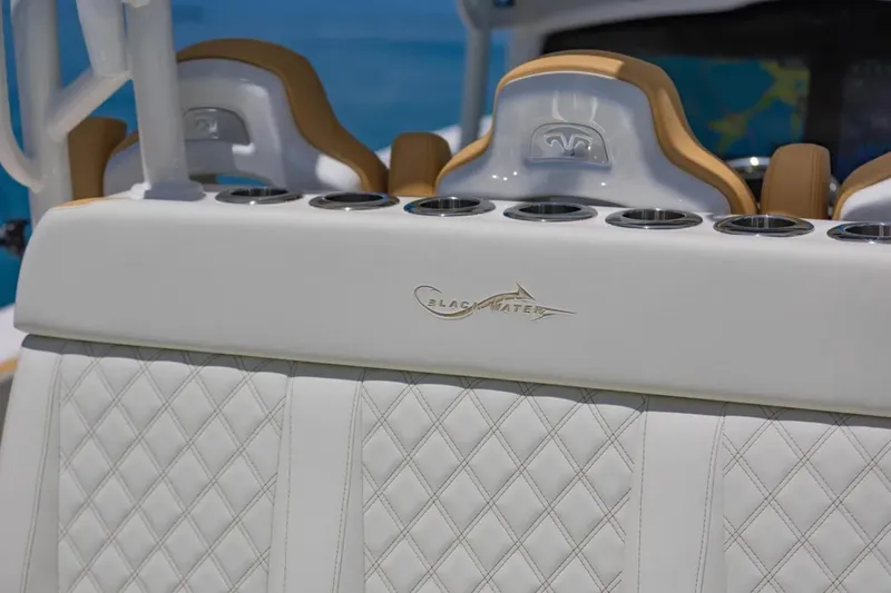Slide: The Image of 2024 Blackwater 43 Sportfish boat interior with diamond-stitched seating and cup holders. - 38