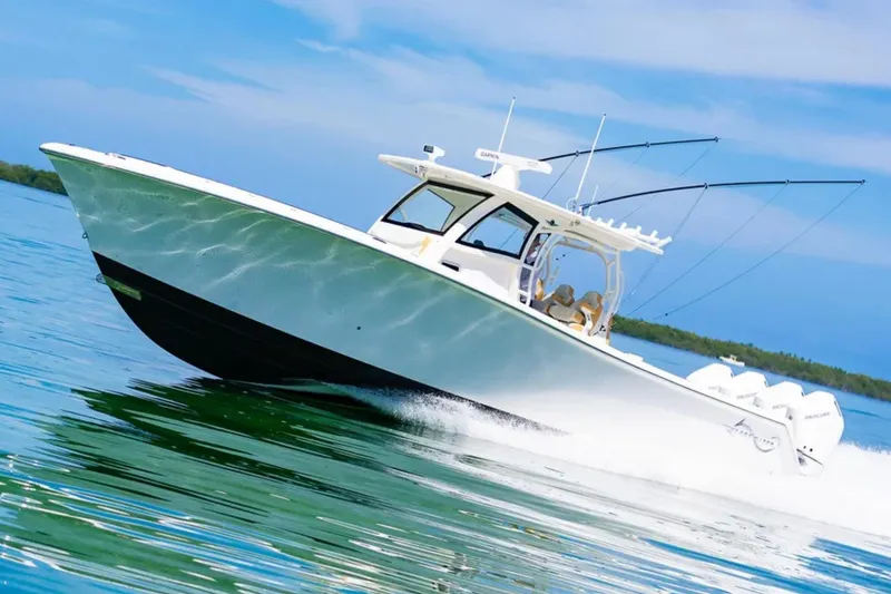 Slide: The Image of 2024 Blackwater 43 Sportfish boat cruising on clear blue water. - 5