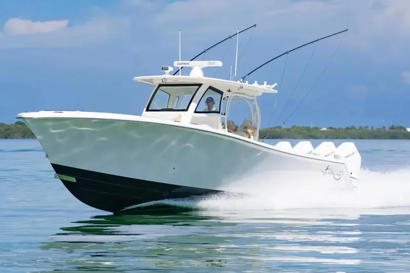 Slide: The Image of 2024 Blackwater 43 Sportfish boat cruising on calm water, showcasing sleek design and powerful engines. - 61