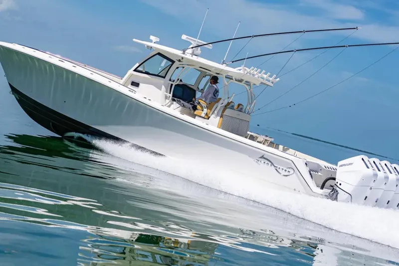 Slide: The Image of 2024 Blackwater 43 Sportfish boat speeding on water, featuring multiple outboard engines. - 63