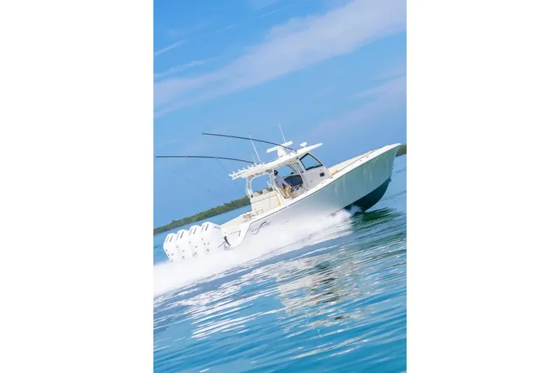 Slide: The Image of 2024 Blackwater 43 Sportfish cruising on clear blue water. - 67
