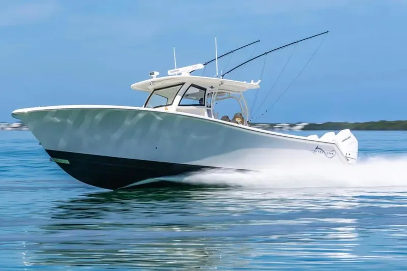 Slide: The Image of 2024 Blackwater 43 Sportfish boat cruising on clear blue water. - 68