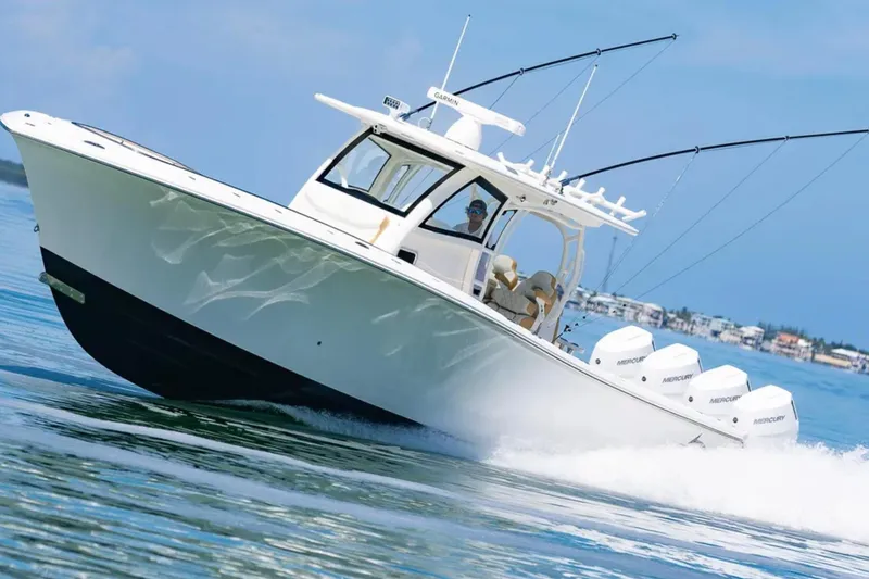 Slide: The Image of 2024 Blackwater 43 Sportfish boat cruising on clear blue water. - 74