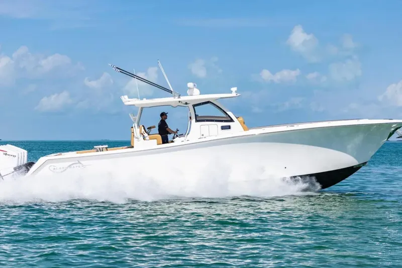 Slide: The Image of 2025 Blackwater 41 Performance Fish boat interior with tan seating and ocean backdrop. - 9