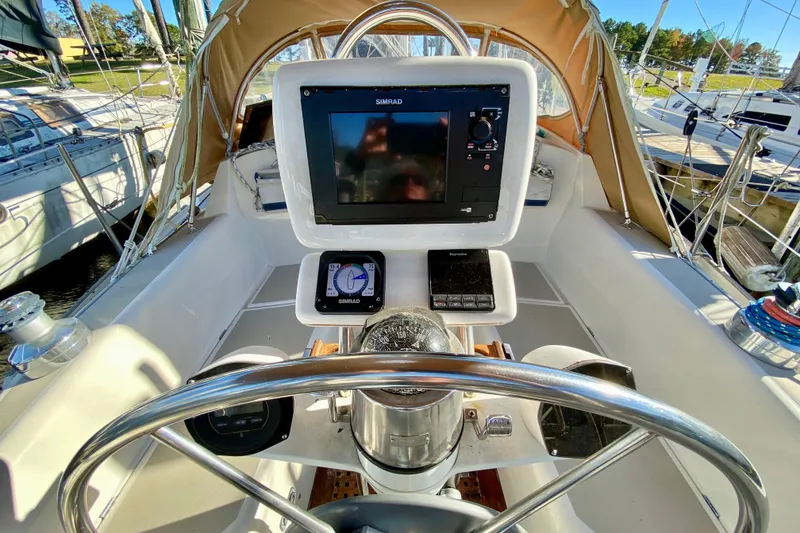 Slide: The Image of Cockpit of 1987 O'Day 34 sailboat with navigation equipment and steering wheel. - 12