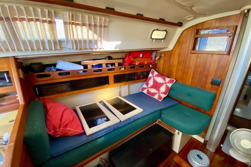 Slide: The Image of Interior of a 1987 O'Day 34 sailboat with cozy seating and nautical decor. - 18