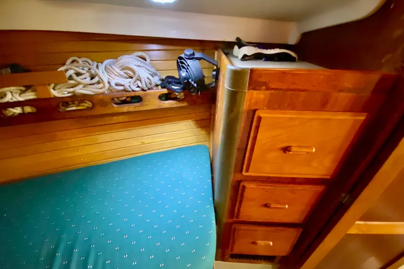 Slide: The Image of Interior of 1987 O'Day 34 sailboat with wooden cabinetry and rope storage. - 22
