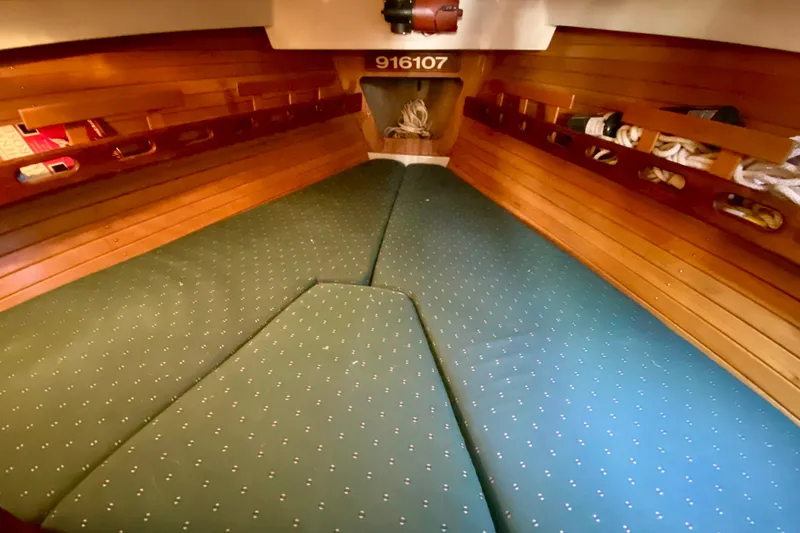 Slide: The Image of Interior cabin of 1987 O'Day 34 sailboat with green cushioned seating. - 23