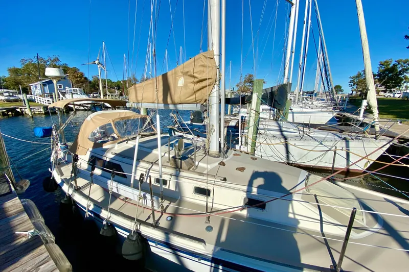 Slide: The Image of 1987 O'Day 34 sailboat docked at marina under clear blue sky. - 4