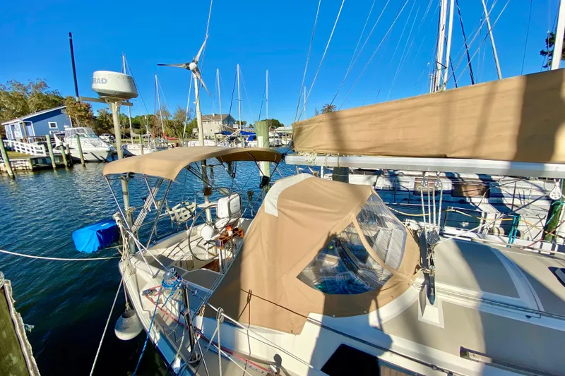 Slide: The Image of 1987 O'Day 34 sailboat docked at marina with tan canvas covers. - 6