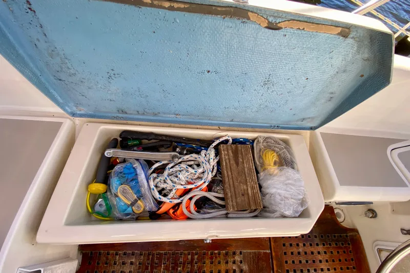 Slide: The Image of Open storage compartment on 1987 O'Day 34 sailboat filled with ropes and tools. - 8