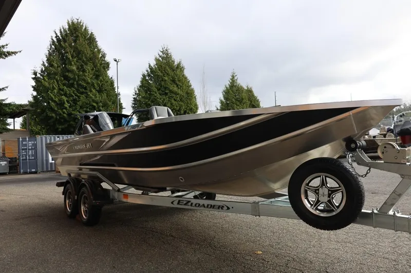 Slide: The Image of 2026 Thunder Jet 229 Rush OT boat on trailer, parked outdoors. - 10