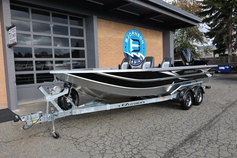 Slide: The Image of 2026 Thunder Jet 229 Rush OT boat on trailer outside Bjornson Marine. - 13