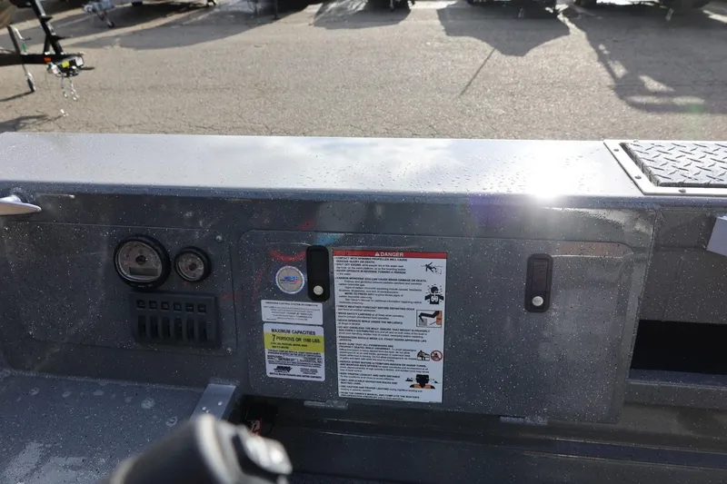 Slide: The Image of Control panel of 2026 Thunder Jet 229 Rush OT boat with gauges and safety warnings. - 23