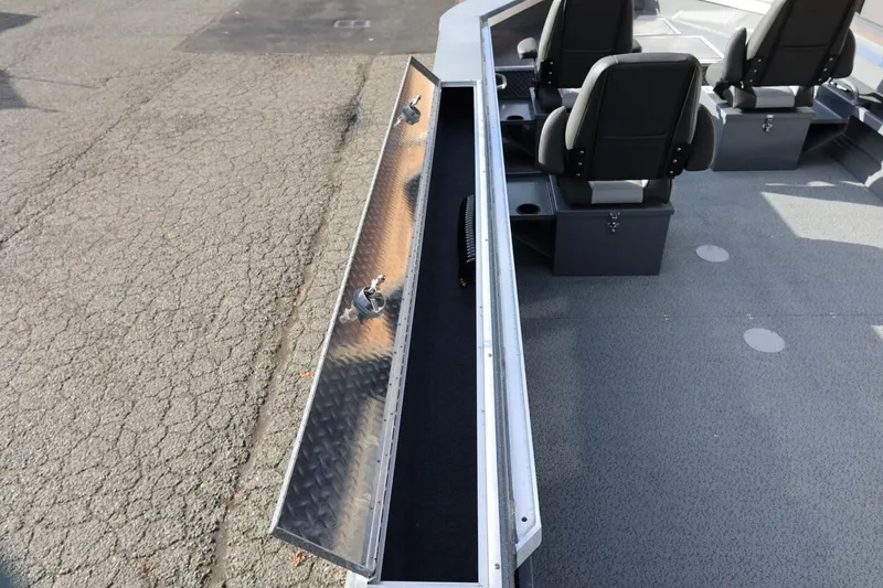 Slide: The Image of Open storage compartment on 2026 Thunder Jet 229 Rush OT boat with seating. - 24