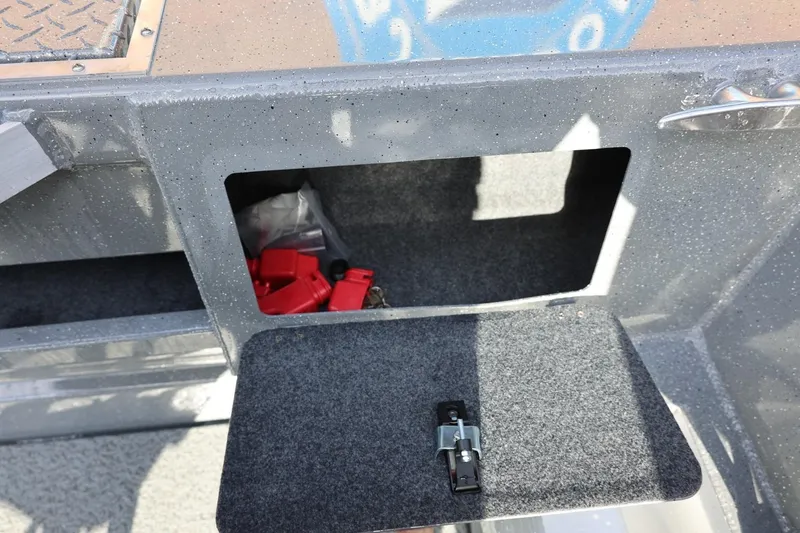 Slide: The Image of Open storage compartment in 2026 Thunder Jet 229 Rush OT boat, showing interior and latch. - 29