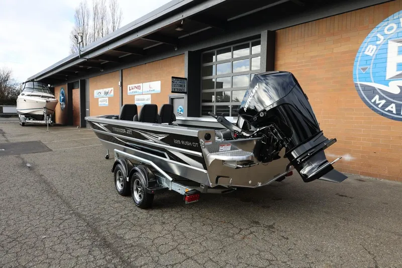 Slide: The Image of 2026 Thunder Jet 229 Rush OT boat with powerful outboard motor in dealership lot. - 3