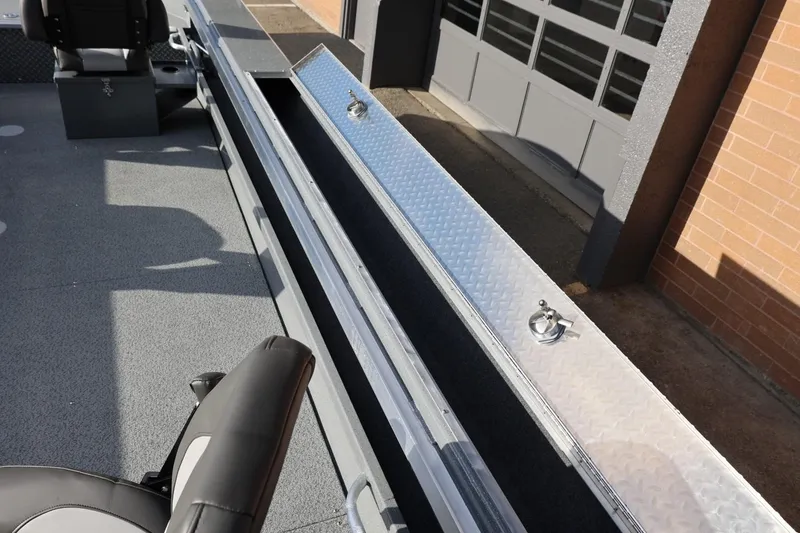 Slide: The Image of 2026 Thunder Jet 229 Rush OT boat interior with storage compartment and seating. - 31