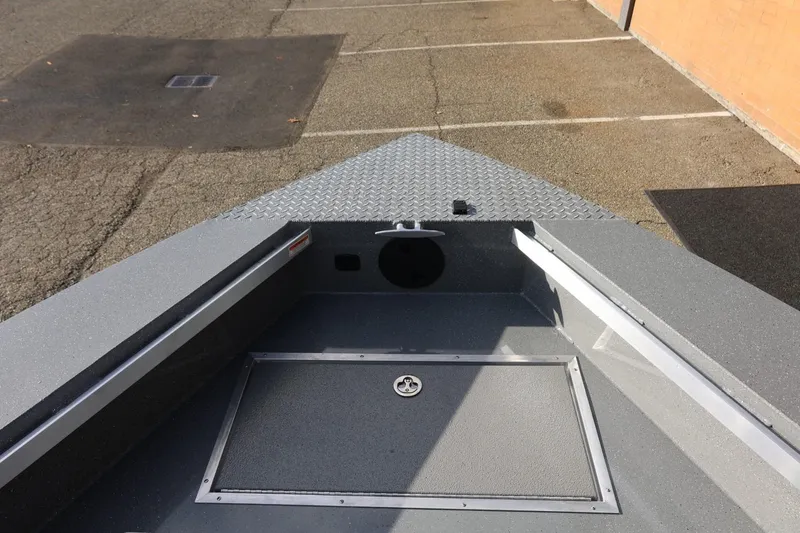 Slide: The Image of 2026 Thunder Jet 229 Rush OT boat interior with storage compartment and diamond plate deck. - 38