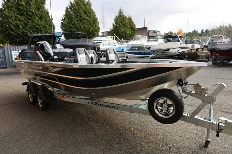 Slide: The Image of 2026 Thunder Jet 229 Rush OT boat on trailer, parked outdoors. - 9