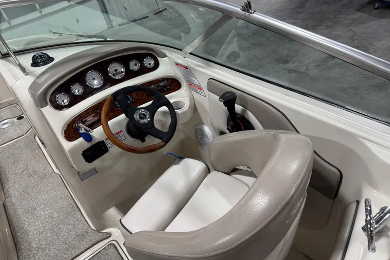 Slide: The Image of 2004 Sea Ray 270 Sundeck boat cockpit with steering wheel and instrument panel. - 10